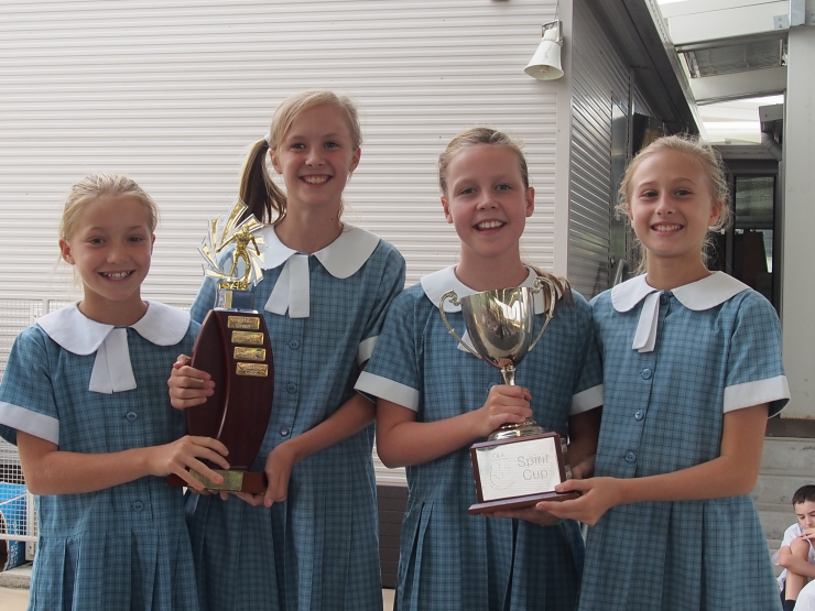 Claudia and Ella holding the winning house trophy and Tiarne and Daniella holding the Spirit Cup.