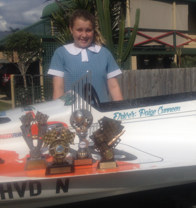 OLA student Paige Cunneen with her trophies and powerboat.