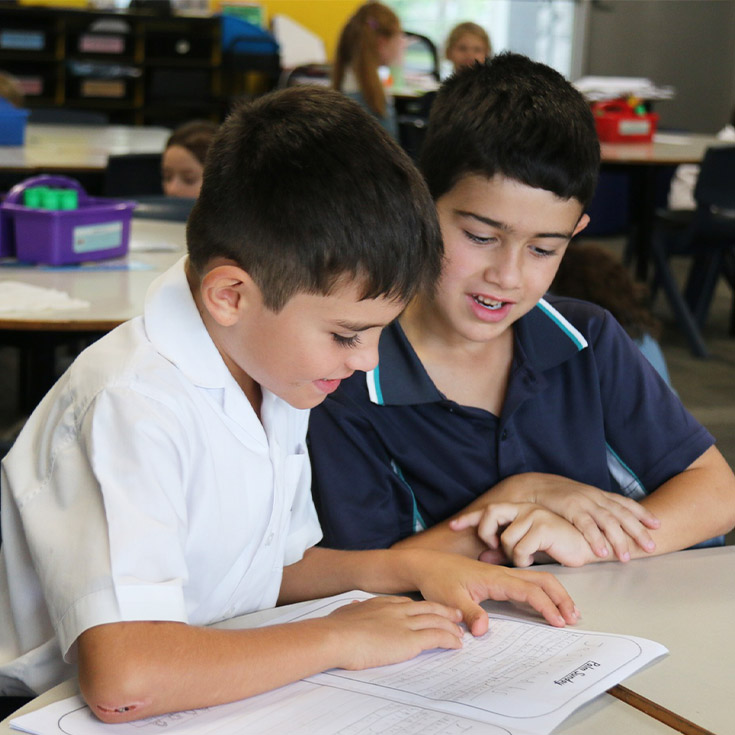 Students reading together at their desk at Our Lady of the Angels Primary School Rouse Hill